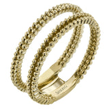 This wedding set features a white gold vintage inspired engagement ring in the center with a yellow gold granulated ring guard that provides a unique look.