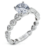 This wedding set features a white gold vintage inspired engagement ring in the center with a yellow gold granulated ring guard that provides a unique look.