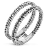 This wedding set features a white gold vintage inspired engagement ring in the center with a yellow gold granulated ring guard that provides a unique look.
