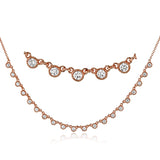 A line of .61 ctw bezel set diamonds lay gracefully across the clavicle in this 18k yellow gold necklace that is perfect for layering.
