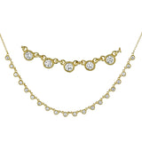 A line of .61 ctw bezel set diamonds lay gracefully across the clavicle in this 18k yellow gold necklace that is perfect for layering.