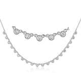 A line of .61 ctw bezel set diamonds lay gracefully across the clavicle in this 18k yellow gold necklace that is perfect for layering.