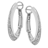 These dynamic 18k white gold hoop earrings contain .27 ctw of white diamonds along the exterior of their distinctive shape.