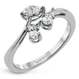 Combining old and new, this fresh take on a three stone ring contains a .15 ct pear shaped diamond, a .16 ct marquise cut diamond and a .15 oval cut diamond.