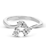Combining old and new, this fresh take on a three stone ring contains a .15 ct pear shaped diamond, a .16 ct marquise cut diamond and a .15 oval cut diamond.