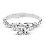 This wedding set stands apart with a unique design featuring two tapered baguette side stones on either side of the center stone, along with .43 ctw of round white accent diamonds.
