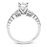 This wedding set stands apart with a unique design featuring two tapered baguette side stones on either side of the center stone, along with .43 ctw of round white accent diamonds.