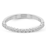 This wedding set stands apart with a unique design featuring two tapered baguette side stones on either side of the center stone, along with .43 ctw of round white accent diamonds.