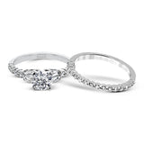 This wedding set stands apart with a unique design featuring two tapered baguette side stones on either side of the center stone, along with .43 ctw of round white accent diamonds.