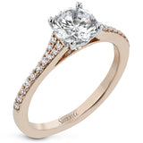 Simple yet stunning, this graceful engagement ring is made for a round cut center stone and is set with .16 ctw of white diamonds.