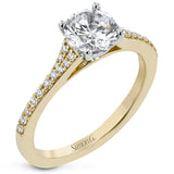 Simple yet stunning, this graceful engagement ring is made for a round cut center stone and is set with .16 ctw of white diamonds.