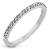 Simple yet stunning, this graceful engagement ring is made for a round cut center stone and is set with .16 ctw of white diamonds.