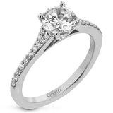 Simple yet stunning, this graceful engagement ring is made for a round cut center stone and is set with .16 ctw of white diamonds.