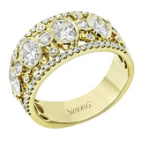 Crafted from 18k yellow gold, this wide fashion ring contains with .52 ctw of white diamonds set within repeating round and oval shapes, creating a lovely effect.