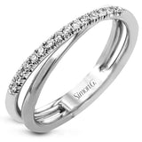 This overlapping two-tone 18k gold ring has a modern look with .15 ctw of white diamonds.