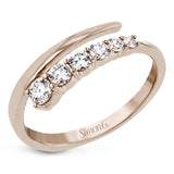 This dynamic 18k gold ring adds the perfect accent to any outfit with .38 ctw of diamonds in a graduated line. This ring can be worn alone or interlocked with its white gold counterpart to create a bold statement.