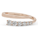 This dynamic 18k gold ring adds the perfect accent to any outfit with .38 ctw of diamonds in a graduated line. This ring can be worn alone or interlocked with its white gold counterpart to create a bold statement.