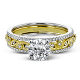 This beautiful two-tone 18k gold wedding set features an organic design white gold inner ring, with a yellow gold jacket surrounding it that is set with .22 ctw of yellow diamonds.