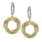 A wreath of gold and diamonds hang from the ear in these lovely earrings that combine 18k yellow and white gold.