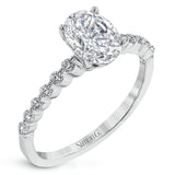 This contemporary wedding set features .48 ctw of diamond side stones and is designed to perfectly showcase an oval center stone.