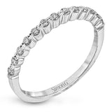This contemporary wedding set features .48 ctw of diamond side stones and is designed to perfectly showcase an oval center stone.