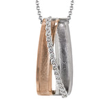 This two-tone pendant features brushed gold textures and .08 ctw of accent diamonds.