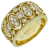 This 18K yellow gold wide right hand ring features clusters of whte diamonds 0.39ctw encircled in gold and 0.24 ctw of bezel set diamonds