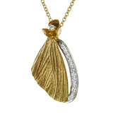 A delicate butterfly's wing crafted in gold is the centerpiece of this pendant, accented by a row of .11 ctw of white diamonds.