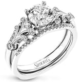 This two-tone gold wedding set features a white gold engagement ring that nestles perfectly into the yellow gold guard that is set with .20 ctw of yellow diamonds.