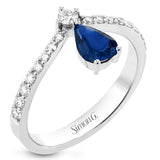This fashionable 18k white gold ring features an inverted teardrop 0.74ct sapphire atop a diamond in the center of its attention-grabbing design.