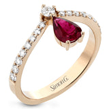 This fashionable 18k rose gold ring features an inverted teardrop 0.65ct ruby atop a diamond in the center of its attention-grabbing design.