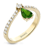 This fashionable18k yellow ring features an inverted teardrop 0.48ct emerald atop a diamond in the center of its attention-grabbing design.