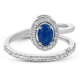 An oval shaped blue sapphire is the star of this 18k white gold ring, set with .32 ctw of white diamonds.