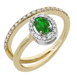 This exceptional ring crafted from 18k yellow gold is set with an oval shaped emerald and .33 ctw of white diamonds.