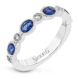 This lovely 18k white gold band is perfect for stacking but can also stand on its own. Blue sapphires are paired with .15 ctw of diamonds.