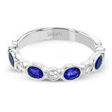This lovely 18k white gold band is perfect for stacking but can also stand on its own. Blue sapphires are paired with .15 ctw of diamonds.