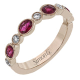This lovely 18k rose gold band is perfect for stacking but can also stand on its own. Beautiful rubies are paired with .16 ctw of diamonds.