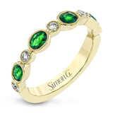 This lovely 18k yellow gold band is perfect for stacking but can also stand on its own. Beautiful green emeralds are paired with .15 ctw of diamonds.