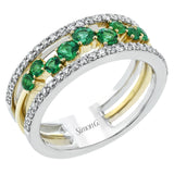This ring features a meandering path of .49 ctw offset emeralds in it midst, flanked by .38 ctw white diamonds along the edges.