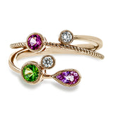 This 18k rose gold spiral ring is sprinkled with colorful gemstones embodying the spirit of springtime, including round white diamonds, a green tsavorite garnet, a pink sapphire and a spinel.
