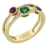 This modern 18k yellow gold double-banded ring features several bezel set gemstones including .36 ctw of rubbies, .28 ctw of emeralds, and .04 ctw of accent diamonds.