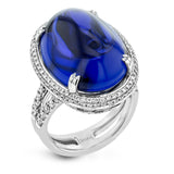This 18k white gold ring is set with a one-of-a-kind 27.24 ct tanzanite cabochon accented by .97 ctw of white diamonds.
