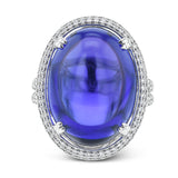 This 18k white gold ring is set with a one-of-a-kind 27.24 ct tanzanite cabochon accented by .97 ctw of white diamonds.