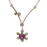This charming 18k rose gold pendant features and bright and cheery gemstone center, accented by .12 ctw of shining diamonds.