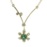This charming 18k yellow gold pendant features and bright and cheery gemstone center, accented by .12 ctw of shining diamonds.