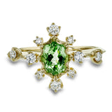 This 18k yellow gold fashion ring is set with .28 ctw of diamonds and a bright tsavorite garnet center stone.