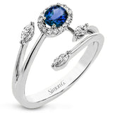This delightful 18k gold ring is set with one .30 ctw sapphire and .06ctw of white round diamonds and .16ctw marquise diamonds in its bypass design