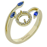 This delightful 18k gold ring is set with one .30 ctw sapphire and .06ctw of white round diamonds and .16ctw marquise diamonds in its bypass design