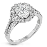 This delightful engagement ring features a scalloped halo that surrounds the center stone like a flower, containing .52 ctw of white diamonds.