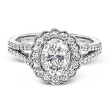 This delightful engagement ring features a scalloped halo that surrounds the center stone like a flower, containing .52 ctw of white diamonds.